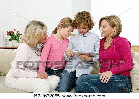 Family using tablet computer View Large Photo Image Stock Photography - Family using tablet computer. Fotosearch