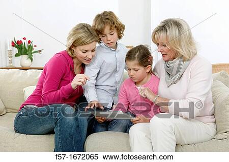 Family using tablet computer View Large Photo Image Stock Photography - Family using tablet computer. Fotosearch