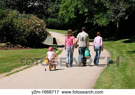 Family walk in the park View Large Photo Image Stock Photo - Family walk in the park. Fotosearch