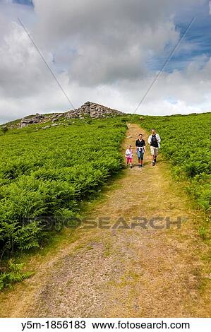 Family walking down from Bell Tor in the Dartmoor National Park, near Widecombe in the Moor, Devon, England, UK, Europe View Large Photo Image Stock Image - Family walking down from Bell Tor in the Dartmoor National Park, near Widecombe in the Moor, Devon, England, UK, Europe. Fotosearch