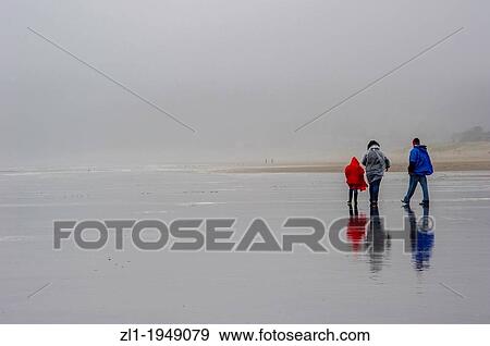 Family walking on rainy day on Cannon Beach. Cannon Beach, Oregon USA. View Large Photo Image Stock Photo - Family walking on rainy day on Cannon Beach. Cannon Beach, Oregon USA.. Fotosearch