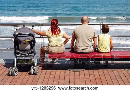 Family watching surfers at Playa de Las Canteras, Las Palmas, Gran Canaria, Canary Islands, Spain View Large Photo Image Stock Photograph - Family watching surfers at Playa de Las Canteras, Las Palmas, Gran Canaria, Canary Islands, Spain. Fotosearch