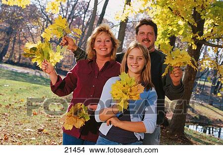 Family with colorful leaves View Large Photo Image Picture - Family with colorful leaves. Fotosearch