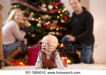 Family with their six month year old baby at Christmas View Large Photo Image Stock Image - Family with their six month year old baby at Christmas. Fotosearch