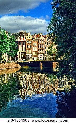 Famous canal and high thin houses on water in Amsterdam Holland Netherlands. View Large Photo Image Stock Photo - Famous canal and high thin houses on water in Amsterdam Holland Netherlands.. Fotosearch