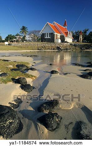 Famous red-roofed chapel/church of Notre Dame de l? Auxiliatrice at low tide Cape Malheureux, Mauritius Island, Indian Ocean View Large Photo Image Picture - Famous red-roofed chapel/church of Notre Dame de l? Auxiliatrice at low tide Cape Malheureux, Mauritius Island, Indian Ocean. Fotosearch