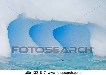 Fanciful designs formed by wind and sea in this iceberg south of the Antarctic Circle on the west side of the Antarctic Peninsula during the summer months View Large Photo Image Stock Photo - Fanciful designs formed by wind and sea in this iceberg south of the Antarctic Circle on the west side of the Antarctic Peninsula during the summer months. Fotosearch