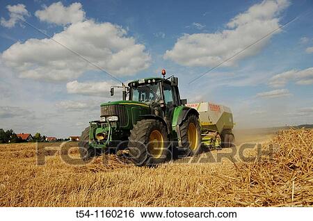 Farmer on the straw presses the field View Large Photo Image Stock Photograph - Farmer on the straw presses the field. Fotosearch