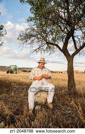 Farmer resting after work in his farmland. Made in August of 2013 in Caud?, a small village in Aragon, close to Teruel. Spain. View Large Photo Image Stock Photo - Farmer resting after work in his farmland. Made in August of 2013 in Caud?, a small village in Aragon, close to Teruel. Spain.. Fotosearch