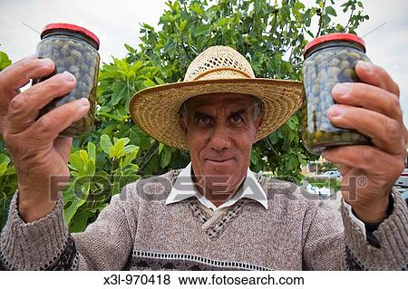 Farmer showing capers Gozo island Malta View Large Photo Image Stock Photo - Farmer showing capers Gozo island Malta. Fotosearch