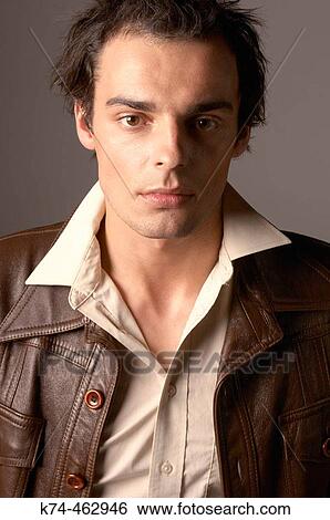 Stock Photograph - fashion image of young man in leather jacket. Fotosearch
