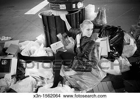 fashion model sitting in garbage pile View Large Photo Image Picture - fashion model sitting in garbage pile. Fotosearch