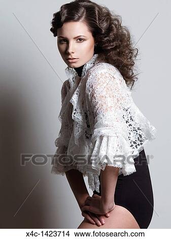 Fashion Photo Of A Young Woman With Beautiful Curly Brown Hair
