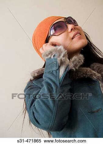 Fashionable chinese girl talking on a cell phone View Large Photo Image Stock Photography - Fashionable chinese girl talking on a cell phone. Fotosearch
