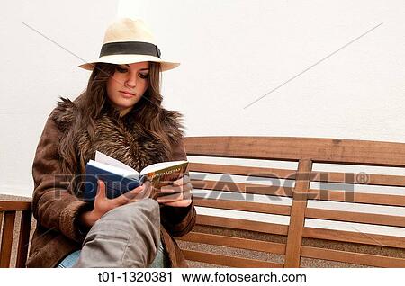 Fashionable girl with Panama hat reading a book outdoors View Large Photo Image Stock Image - Fashionable girl with Panama hat reading a book outdoors. Fotosearch