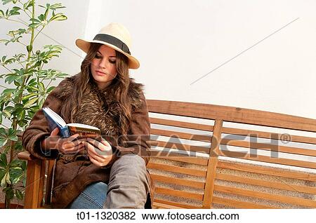 Fashionable girl with Panama hat reading a book outdoors View Large Photo Image Stock Image - Fashionable girl with Panama hat reading a book outdoors. Fotosearch