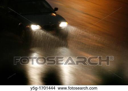 fast car driving in heavy rain at night in town View Large Photo Image Picture - fast car driving in heavy rain at night in town. Fotosearch