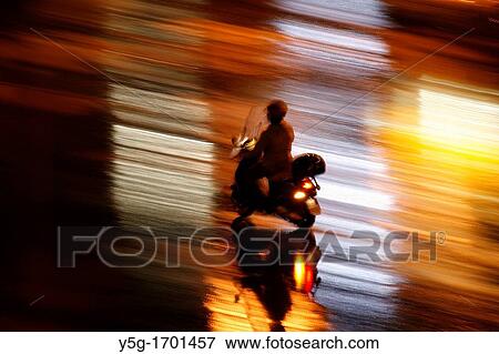 fast motorbike rider heavy rain at night in town View Large Photo Image Stock Photo - fast motorbike rider heavy rain at night in town. Fotosearch