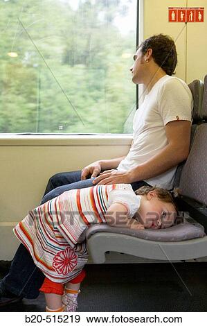 Stock Photo - Father (35 years old) and daughter (2 years old) travelling in tramway.. Fotosearch