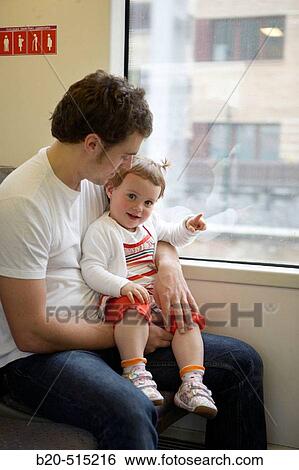 Father (35 years old) and daughter (2 years old) travelling in tramway. View Large Photo Image Stock Photograph - Father (35 years old) and daughter (2 years old) travelling in tramway.. Fotosearch