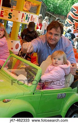 Father and 18 month old baby on a fairground ride. View Large Photo Image Stock Image - Father and 18 month old baby on a fairground ride.. Fotosearch