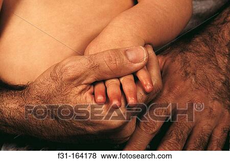 Stock Photo - Father and baby hands. Fotosearch
