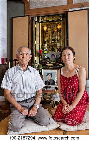 Father and daughter at family shrine in home, Tosu, Saga, Japan. View Large Photo Image Picture - Father and daughter at family shrine in home, Tosu, Saga, Japan.. Fotosearch