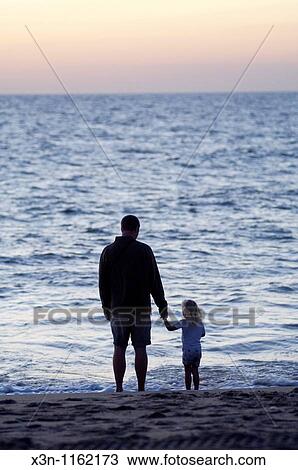 Stock Image - Father and daughter at Rehoboth Beach, Delaware. Fotosearch