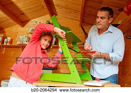 Father and daughter doing DIY. Assembling a chair. View Large Photo Image Picture - Father and daughter doing DIY. Assembling a chair.. Fotosearch