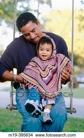 Picture - father and daughter on a swing. Fotosearch