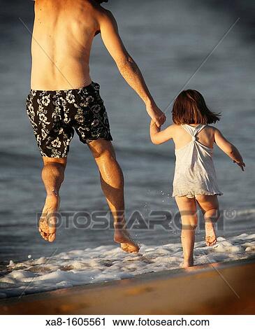 FATHER AND DAUGHTER PLAYING ON THE BEACH IN GALICIA SPAIN VALDOVI? O View Large Photo Image Stock Image - FATHER AND DAUGHTER PLAYING ON THE BEACH IN GALICIA SPAIN VALDOVI? O. Fotosearch