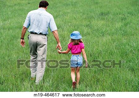 father and daughter walking hand in hand View Large Photo Image Stock Photo - father and daughter walking hand in hand. Fotosearch