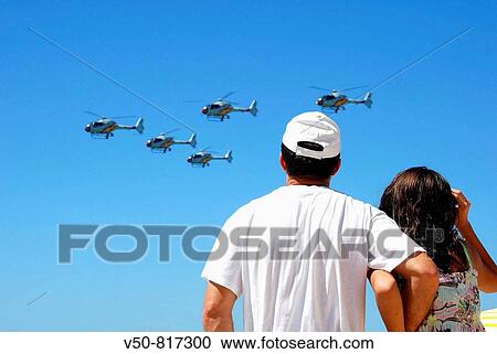 Father and daughter watching helicopters during an Air force Exhibition in Victoria beach, Cadiz, Spain, held on 23rd September 2008 View Large Photo Image Stock Image - Father and daughter watching helicopters during an Air force Exhibition in Victoria beach, Cadiz, Spain, held on 23rd September 2008. Fotosearch