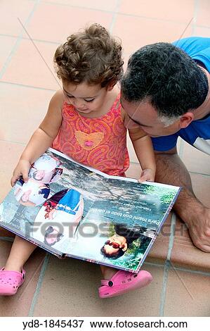 Father and daughter watching your family photo album, Barcelona, Catalonia, Spain, Europe View Large Photo Image Stock Photo - Father and daughter watching your family photo album, Barcelona, Catalonia, Spain, Europe. Fotosearch