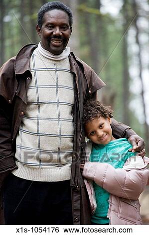 Father and Daughter, young child, enjoy each other's company walking through a forest View Large Photo Image Stock Photograph - Father and Daughter, young child, enjoy each other's company walking through a forest. Fotosearch