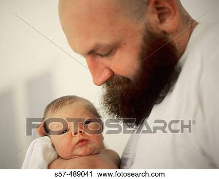 Stock Image - Father and new born baby in maternity hospital.. Fotosearch