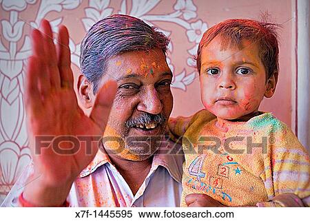 Father and son celebrating the Holi spring festival to celebrate the love between Krishna and Radha, in Govind Devji temple, Jaipur, Rajasthan, India View Large Photo Image Stock Photography - Father and son celebrating the Holi spring festival to celebrate the love between Krishna and Radha, in Govind Devji temple, Jaipur, Rajasthan, India. Fotosearch