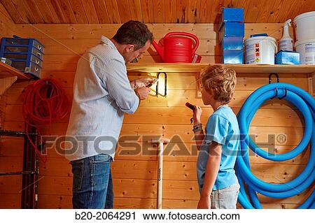 Father and son doing DIY. Holding a shelf. View Large Photo Image Stock Image - Father and son doing DIY. Holding a shelf.. Fotosearch