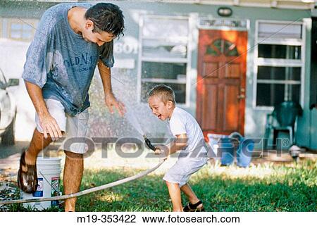 father and son having a water fight View Large Photo Image Stock Image - father and son having a water fight. Fotosearch