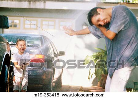 father and son having a water fight View Large Photo Image Stock Photo - father and son having a water fight. Fotosearch