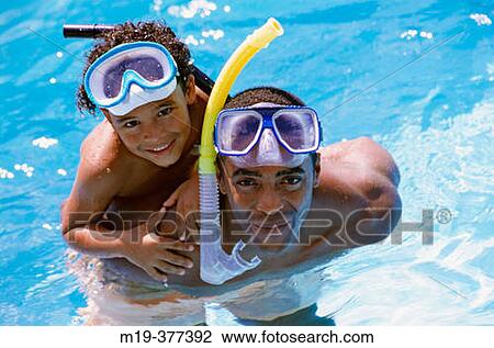 father and son in a swiming pool View Large Photo Image Stock Image - father and son in a swiming pool. Fotosearch