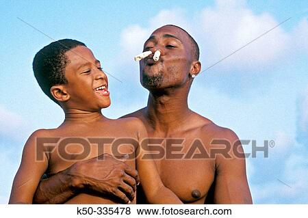 Father and son making fun at the beach, Curacao View Large Photo Image Stock Photo - Father and son making fun at the beach, Curacao. Fotosearch