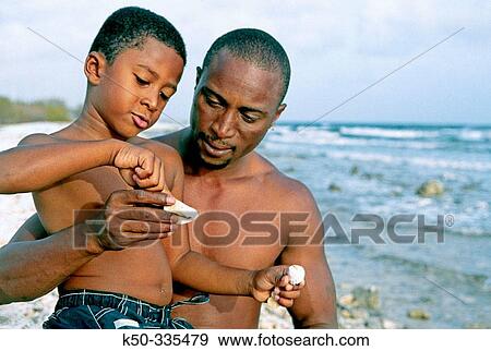 Father and son making fun at the beach, Curacao View Large Photo Image Stock Photo - Father and son making fun at the beach, Curacao. Fotosearch
