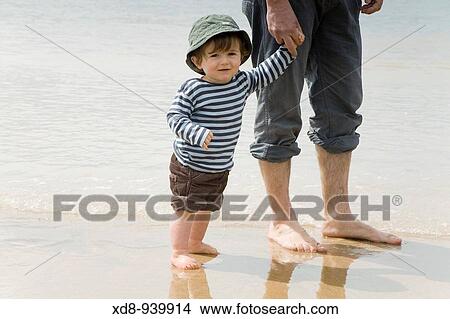 father and son on the beach View Large Photo Image Picture - father and son on the beach. Fotosearch