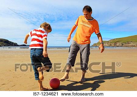 father and son playing football on beach, Sutherland, Scotland View Large Photo Image Stock Image - father and son playing football on beach, Sutherland, Scotland. Fotosearch