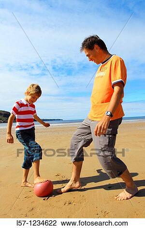 father and son playing football on beach, Sutherland, Scotland View Large Photo Image Stock Image - father and son playing football on beach, Sutherland, Scotland. Fotosearch