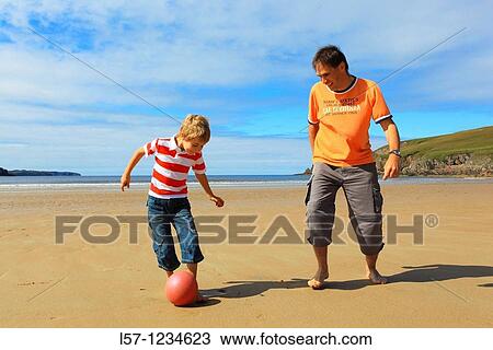 father and son playing football on beach, Sutherland, Scotland View Large Photo Image Stock Image - father and son playing football on beach, Sutherland, Scotland. Fotosearch