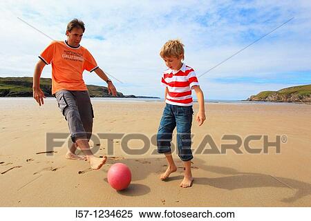 father and son playing football on beach, Sutherland, Scotland View Large Photo Image Stock Photography - father and son playing football on beach, Sutherland, Scotland. Fotosearch