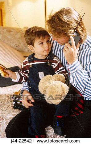 Father and son talking on cell phone in bedroom View Large Photo Image Stock Image - Father and son talking on cell phone in bedroom. Fotosearch