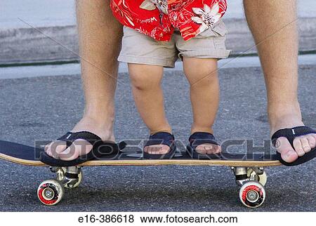 father and son together on skateboard View Large Photo Image Stock Photo - father and son together on skateboard. Fotosearch